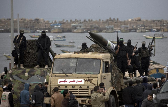 palestinian militants of the izzadine al qassam brigades hamas 039 armed wing displaying a locally made made rocket during a parade in gaza city photo afp palestinian militants of the izzadine al qassam brigades hamas 039 armed wing displaying a locally made made rocket during a parade in gaza city photo afp