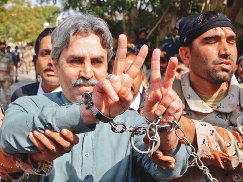 mqm leader amir khan signals the victory sign for cameramen as he was brought to the atc after being arrested from the party headquarters on march 11 photo file