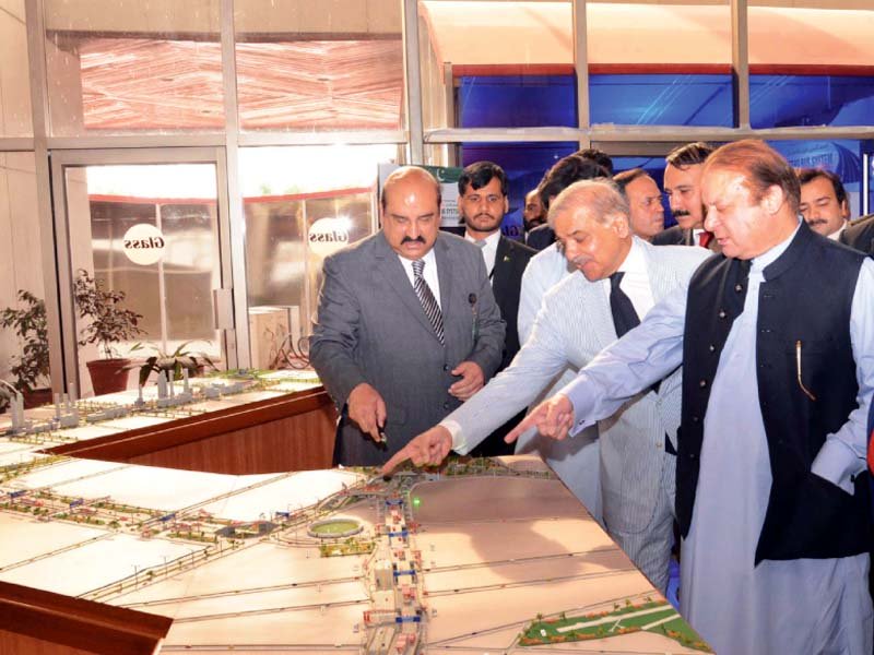 pm nawaz studies the layout of the bus service route photo afp