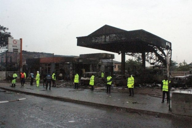 policemen stand guard as rescuers work on the site where at least 90 people were killed in a petrol station fire in accra photo afp policemen stand guard as rescuers work on the site where at least 90 people were killed in a petrol station fire in accra photo afp