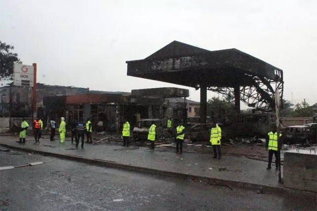 policemen stand guard as rescuers work on the site where at least 90 people were killed in a petrol station fire in accra photo afp policemen stand guard as rescuers work on the site where at least 90 people were killed in a petrol station fire in accra photo afp