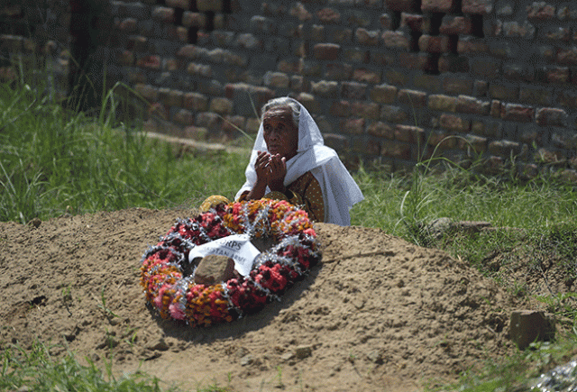 ayesha bibi wife of a late pakistani man who served in the british army during world war ii at the grave of her husband in the village of dhudial photo afp
