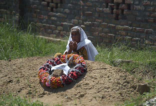 ayesha bibi wife of a late pakistani man who served in the british army during world war ii at the grave of her husband in the village of dhudial photo afp