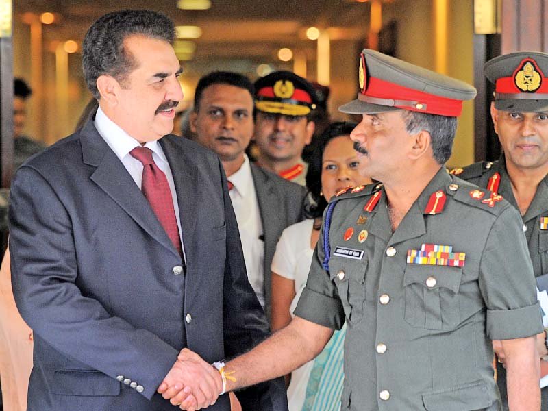 gen raheel shakes hands with his sri lankan counterpart after landing in colombo photo afp