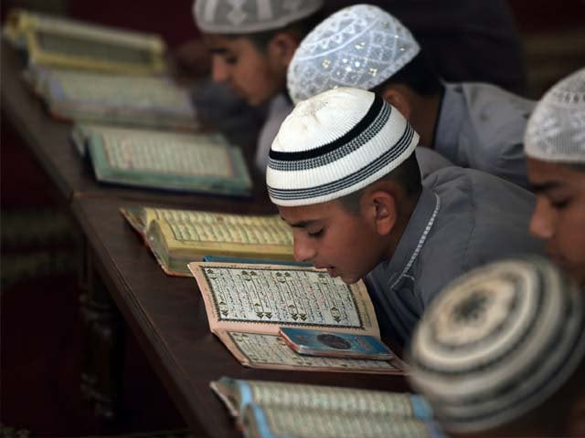 pakistani students at a madrassa recite the quran photo afp pakistani students at a madrassa recite the quran photo afp