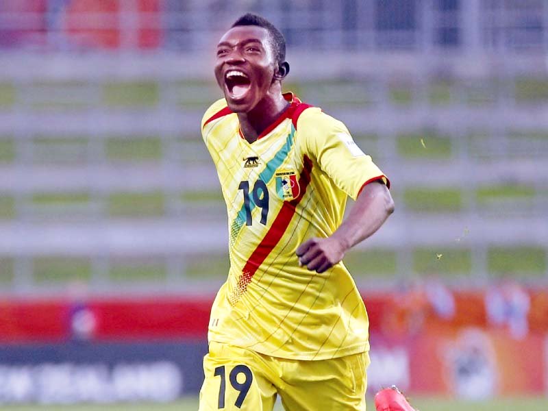 malian adama traore celebrates after scoring the free kick that levelled the score against uruguay to send them through as one of the best third placed sides photo afp