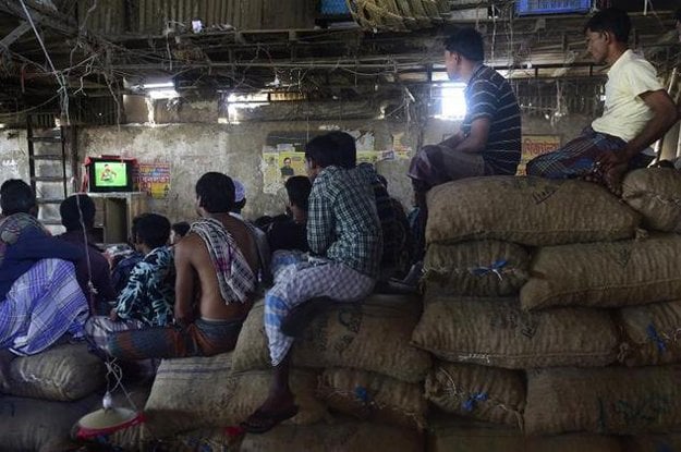 bangladeshi cricket fans watch the live broadcast of the cricket world cup match between india and bangladesh at a wholesale market in dhaka on march 19 2015 photo afp