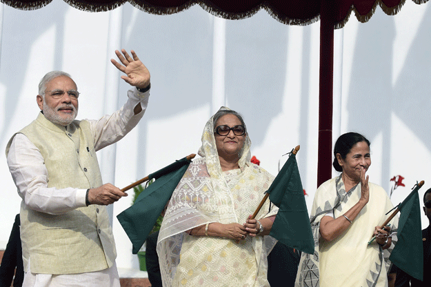 indian prime minister narendra modi bangladeshi prime minister sheikh hasina and west bengal chief minister kumari mamata banerjee attend the inauguration of international bus services between india and bangladesh in dhaka on june 6 2015 bangladesh and india on june 6 sealed a historic land pact to swap territories which will finally allow tens of thousands of people living in border enclaves to choose their nationality after decades of stateless limbo photo afp