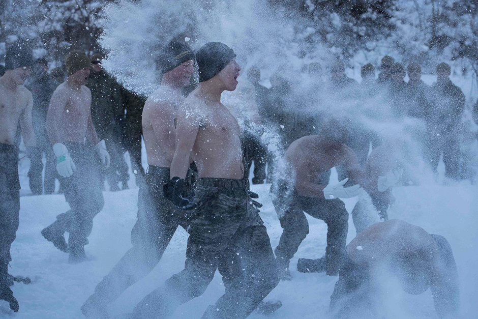 South Korean and US soldiers throw snow on themselves during a photo opportunity as part of a joint annual winter exercise in Pyeongchang, some 180 kilometres east of Seoul. PHOTO: AFP