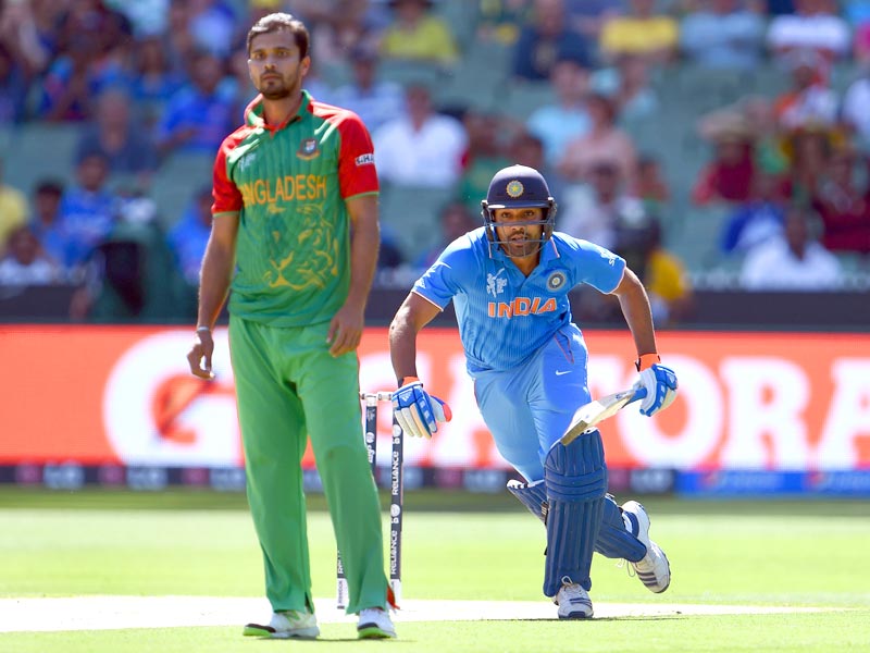 rohit sharma takes a run as bangladesh bowler and captain mashrafe mortaza looks on during the 2015 world cup quarter final match between india and bangladesh in melbourne photo afp