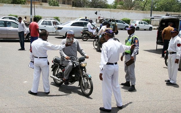 traffic police wardens stopping motorcyclist riding without safety helmets photo sabir mazhar