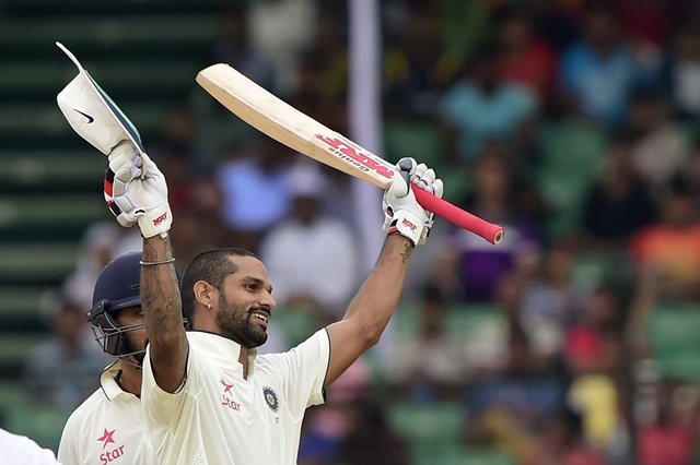 indian cricketer shikhar dhawan reacts after scoring a century 100 runs during the first day of the first cricket test match between bangladesh and india at khan shaheb osman ali stadium in narayanganj on june 10 2015 photo afp