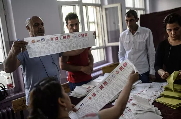 election officials hold ballot papers with the names of political parties participating in the nationwide legislative election as they count votes in a primary school in diyarbakir on june 7 2015 photo afp election officials hold ballot papers with the names of political parties participating in the nationwide legislative election as they count votes in a primary school in diyarbakir on june 7 2015 photo afp
