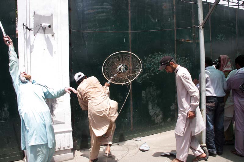 a protester smashing a fan against the pa gate photo abid nawaz express