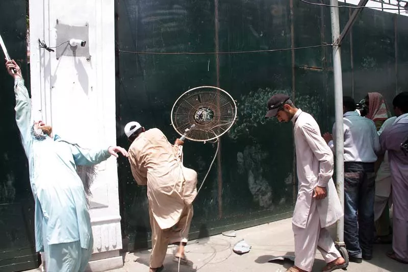 a protester smashing a fan against the pa gate photo abid nawaz express a protester smashing a fan against the pa gate photo abid nawaz express