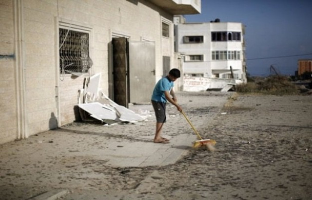 a palestinian boy cleans debris near a training base of the ezzedine al qassam brigades the military wing of hamas in gaza city after israeli warplanes struck multiple militant targets in the palestinian coastal strip on june 4 2015 in response to palestinian rocket fire photo afp a palestinian boy cleans debris near a training base of the ezzedine al qassam brigades the military wing of hamas in gaza city after israeli warplanes struck multiple militant targets in the palestinian coastal strip on june 4 2015 in response to palestinian rocket fire photo afp