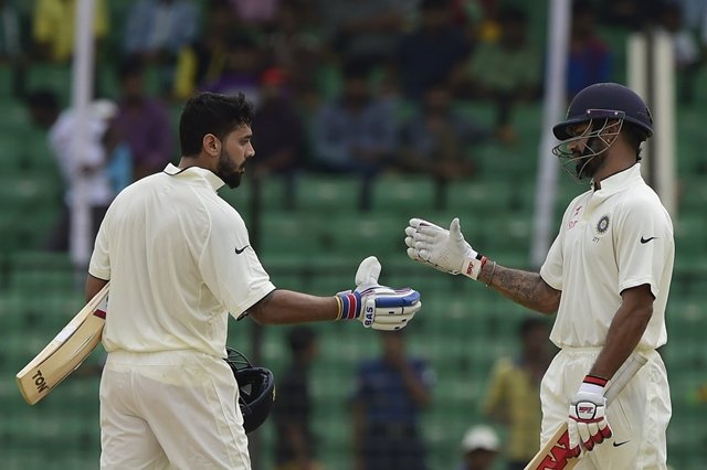 india 039 s murali vijay l celebrates his century with teammate shikhar dhawan during the third day of the cricket test match between bangladesh and india at khan shaheb osman ali stadium in narayanganj on june 12 2015 photo afp