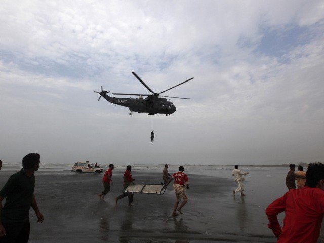 file photo of rescue workers in red shirts carrying a stretcher as they run to receive the body of a victim who had drowned at karachi 039 s clifton beach july 31 2014 photo reuters