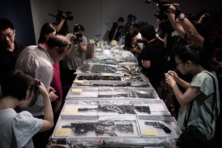 riffles and other seized items are displayed before a press conference at the police headquarters in hong kong on june 15 2015 after suspected explosives were seized at an abandoned television studio in the east coast district of sai kung photo afp