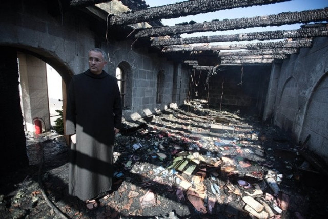 a priest inspects the damage at a room located on the complex of the church of the multiplication at tabgha on the shores on the sea of galilee in northern israel on june 18 2015 in the aftermath of a suspected arson attack photo afp a priest inspects the damage at a room located on the complex of the church of the multiplication at tabgha on the shores on the sea of galilee in northern israel on june 18 2015 in the aftermath of a suspected arson attack photo afp