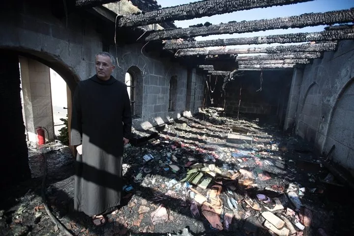 a priest inspects the damage at a room located on the complex of the church of the multiplication at tabgha on the shores on the sea of galilee in northern israel on june 18 2015 in the aftermath of a suspected arson attack photo afp a priest inspects the damage at a room located on the complex of the church of the multiplication at tabgha on the shores on the sea of galilee in northern israel on june 18 2015 in the aftermath of a suspected arson attack photo afp