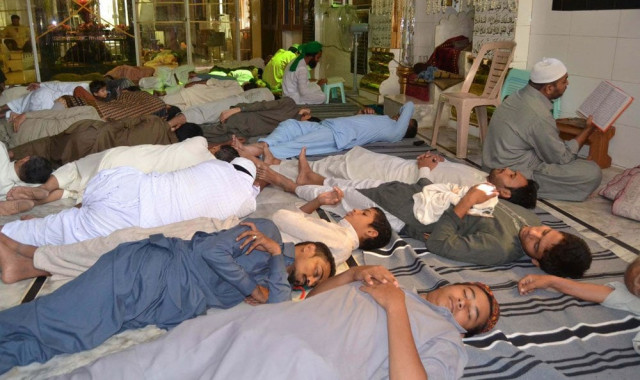 men rest during fajr at a mosque on the first day of ramazan in karachi photo inp men rest during fajr at a mosque on the first day of ramazan in karachi photo inp