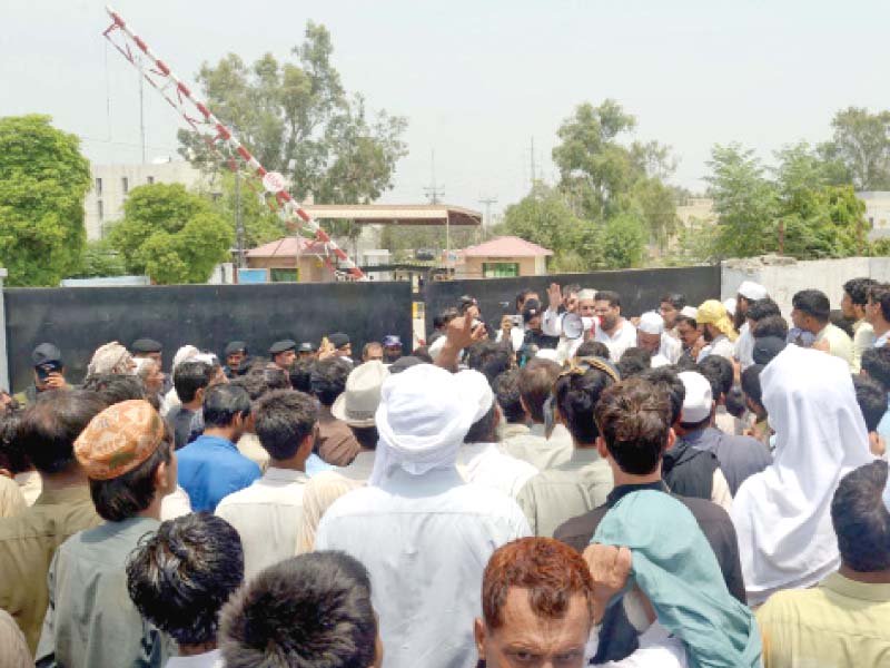 residents of urmar village protest outside wapda house photo ppi