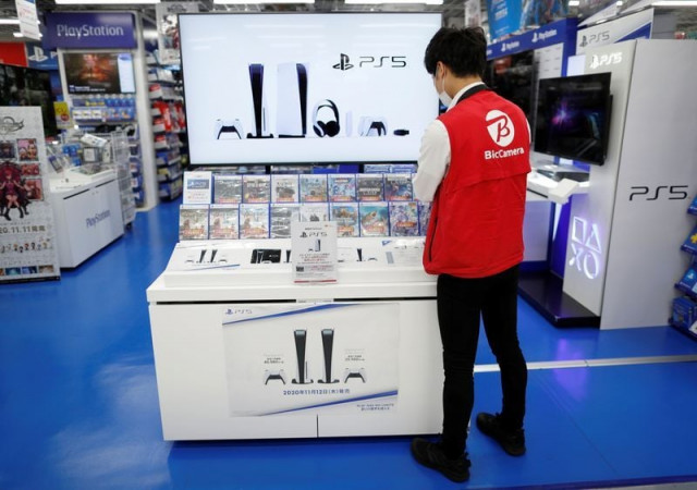 an employee of the consumer electronics retailer chain bic camera works at the promotion display for the sony playstation 5 game console and its gaming softwares in tokyo japan november 10 2020 photo reuters an employee of the consumer electronics retailer chain bic camera works at the promotion display for the sony playstation 5 game console and its gaming softwares in tokyo japan november 10 2020 photo reuters