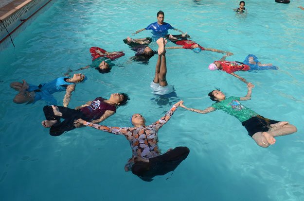 indian children perform water yoga as they take part in a mass yoga session to mark the international yoga day at dau ri dhani swiming pool in jodhpur on june 21 2015 photo afp