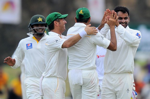 pakistan cricketer mohammad hafeez r and teammates celebrate after the dismissal of unseen sri lankan cricketer lahiru thirimanne during the second day of the opening test cricket match between sri lanka and pakistan at the galle international cricket stadium in galle on june 18 2015 photo afp