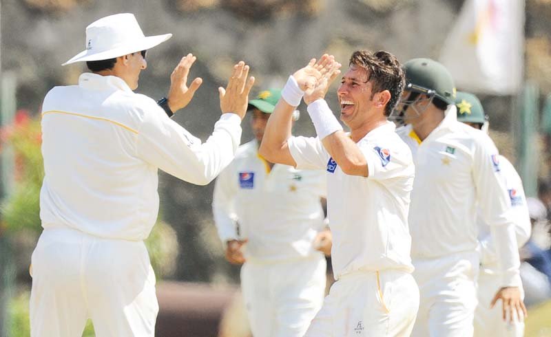 yasir celebrates with misbah as pakistan claimed a convincing 10 wicket win they have now won 123 test matches more than any other asian side edging india s 122 photo afp