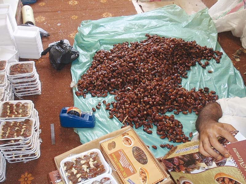 vendors lay out dates at the ramazan bachat bazaar set up by the sukkur small traders daily commodities are being sold 20 to 30 per cent cheaper here than in the open market photo express