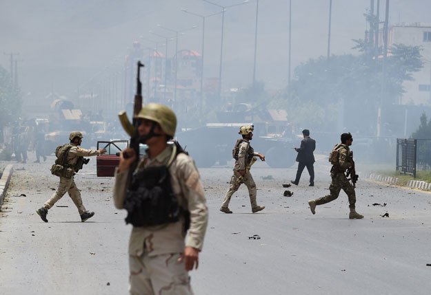 afghan security personnel take position at the site of an attack in front of the parliament building in kabul on june 22 2015 photo afp