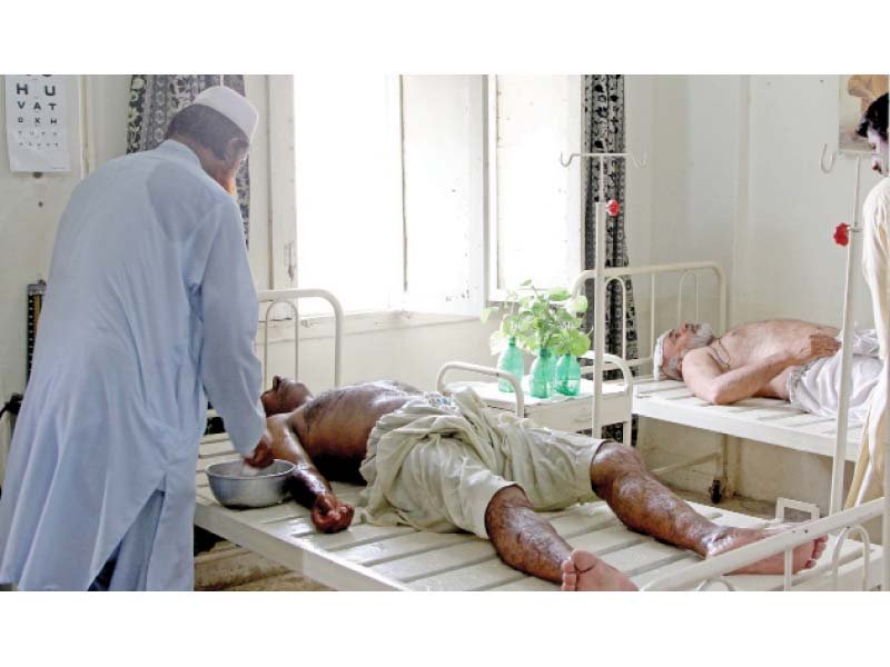 water is poured on a man suffering from heatstroke at a rangers heatstroke relief centre in kala pull photo aysha saleem express