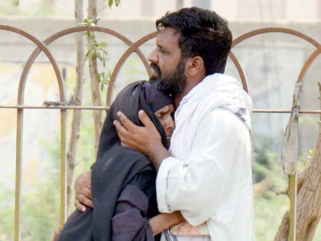 a family mourns the death of a relative outside the edhi morgue in karachi photo inp
