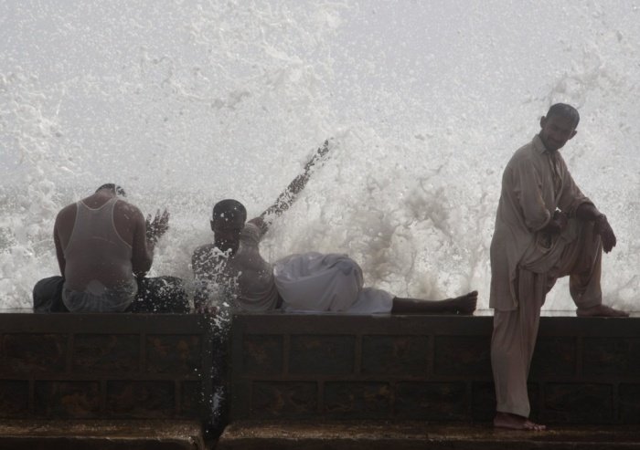 men cool off at sea view in karachi photo ap