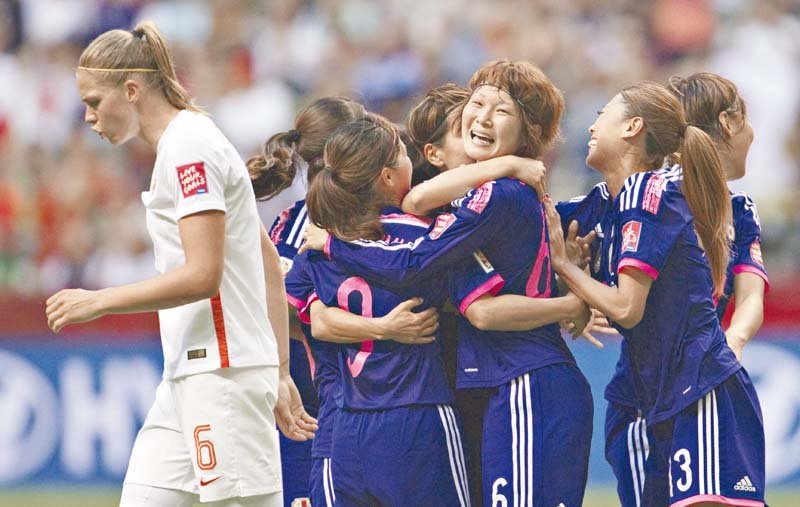 japan s saori ariyoshi and mizuho sakaguchi scored in either half for the defending champions who are the only team left in canada to have won all their matches photo afp