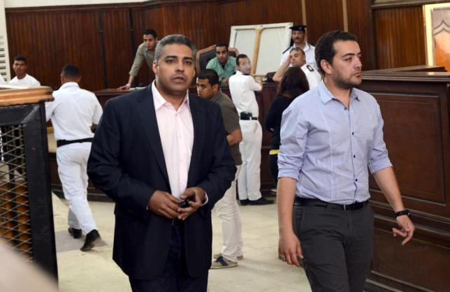 al jazeera television journalists mohamed fahmy l and baher mohamed are seen at a court in cairo after their retrial april 22 2015 photo reuters