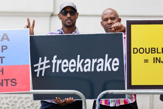 demonstrators call for the release of rwanda 039 s intelligence chief general karenzi karake outside westminster magistrates court in london on june 25 2015 photo afp demonstrators call for the release of rwanda 039 s intelligence chief general karenzi karake outside westminster magistrates court in london on june 25 2015 photo afp