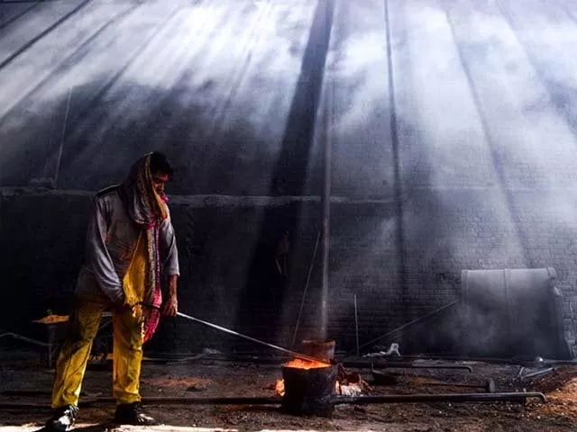 a pakistani labourer working at an iron factory photo afp a pakistani labourer working at an iron factory photo afp