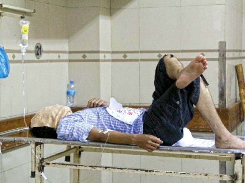 a patient lies on an examination table after being administered a drip abbasi shaheed hospital is running out of space to facilitate the number of patients that are coming in with heat related illnesses photo aysha saleem express