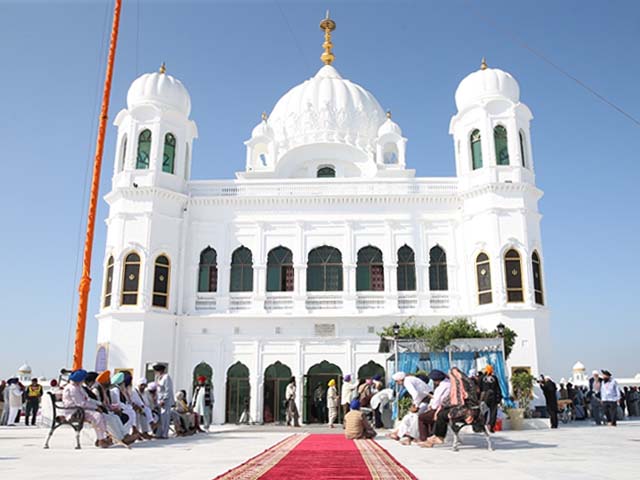 sikh pilgrims gather to offer prayers towards the temple of baba guru nanak dev photo getty