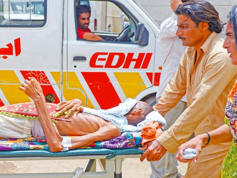 relatives rush a heatstroke patient to a hospital in karachi photo afp