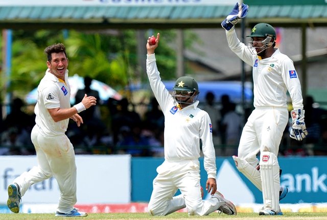 pakistan cricketer yasir shah l celebrates with teammates azhar ali c and wicketkeeper sarfraz ahmed after dismissing sri lankan cricketer lahiru thirimanne during the second day of the second test cricket match between sri lanka and pakistan at the p sara oval cricket stadium in colombo on june 26 2015 photo afp