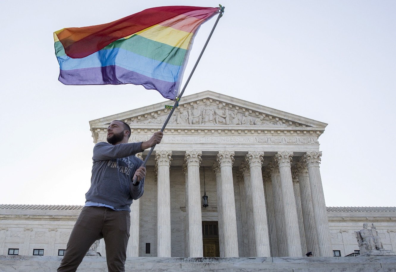 vin testa of washington dc waves a gay rights flag in front of the supreme court before a hearing about gay marriage in washington in an april 28 2015 file photo photo reuters