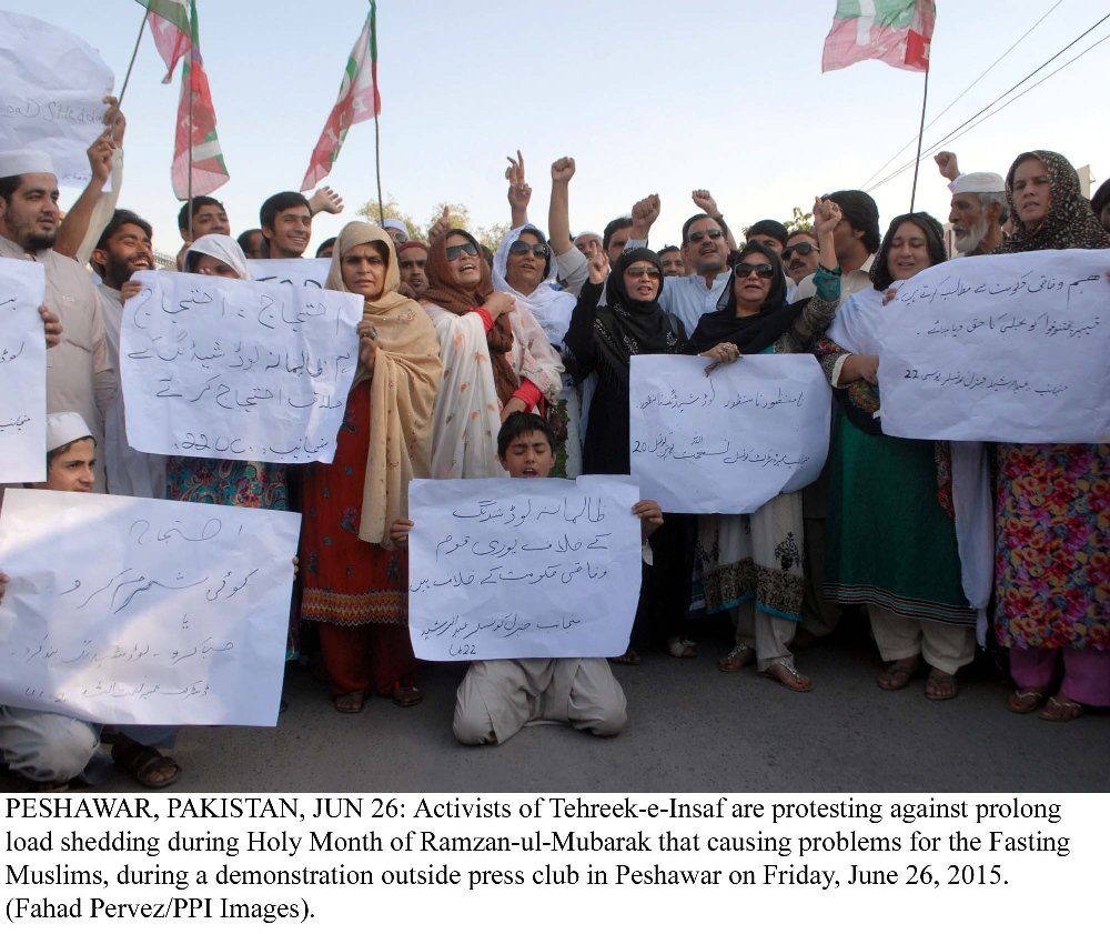 pti activists protest against prolonged load shedding during ramazan in peshawar on friday june 26 2015 photo ppi