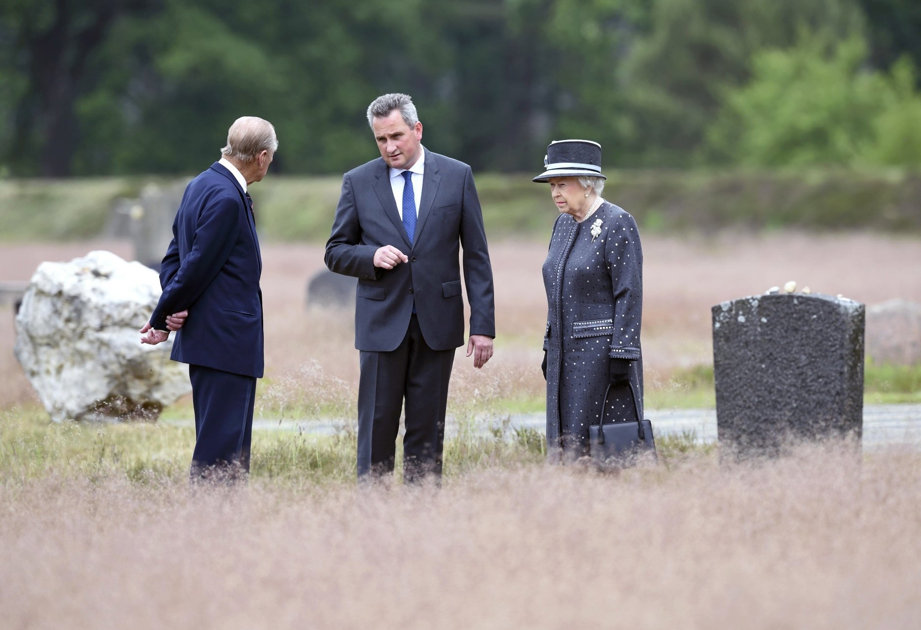 britain 039 s queen elizabeth ii and the duke of edinburg prince philip l are show the memorial site of former nazi concentration camp bergen belsen by memorial site director jens christian wagner c on june 26 2015 photo afp