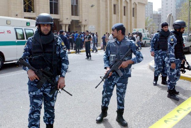 security forces gather outside the shia al imam al sadeq mosque after it was targeted by a suicide bombing during friday prayers in kuwait city on june 26 2015 photo afp