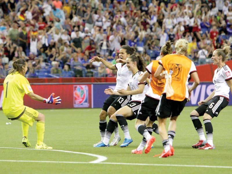 german players run towards their keeper and captain nadine angerer after she saved the deciding french penalty to send her team through photo afp