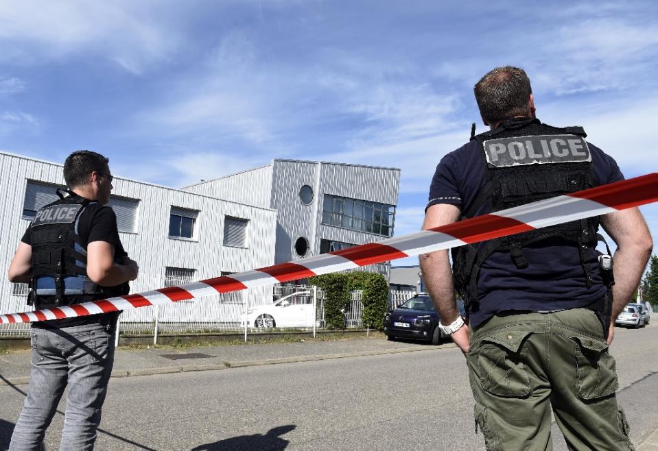 french police officers stand guard near a cordon outside the delivery service company in chassieu on june 26 2015 where the victim who was decapitated worked photo afp